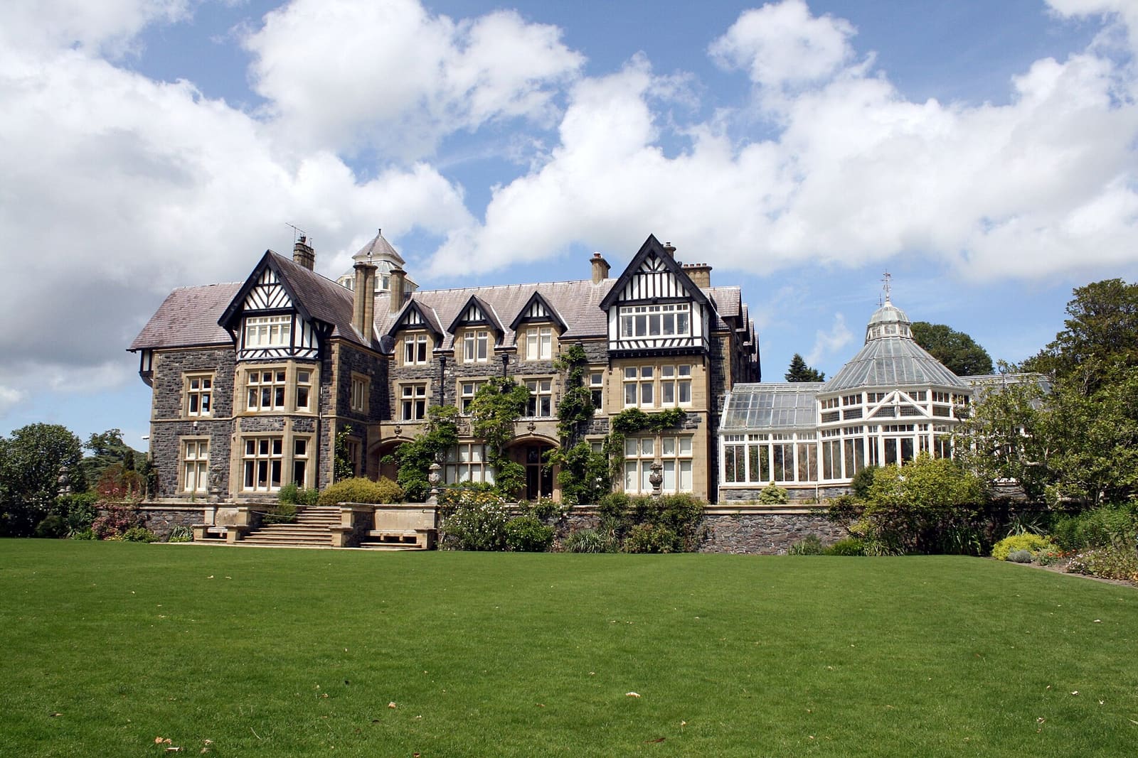 Wide manicured lawn stretching in front of a stately home
